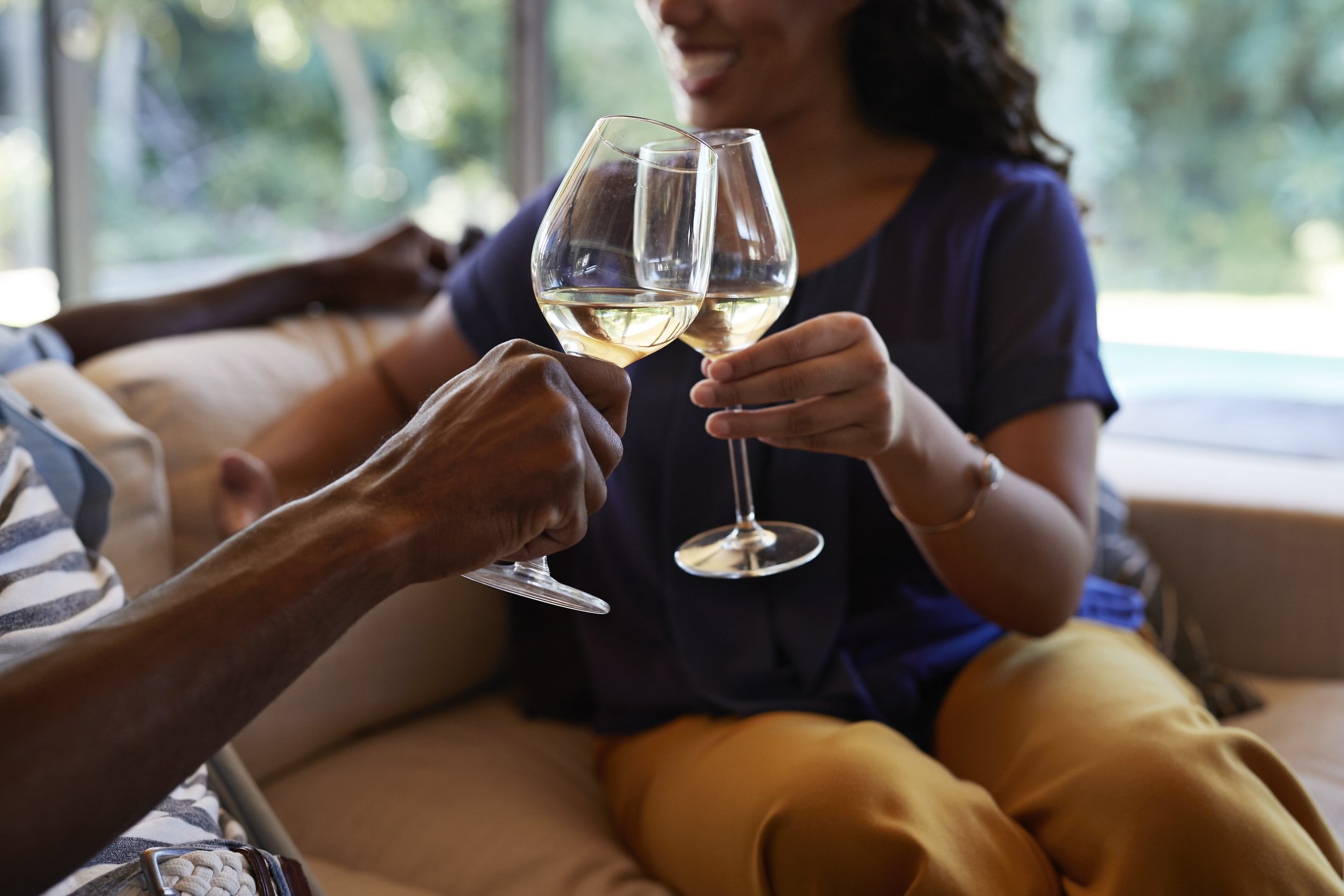 Brinde com taças de vinho branco; consumo moderado associado ao fortalecimento do sistema imunológico.