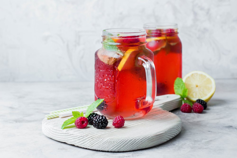 Pink lemonade com suco de cranberry, folhas de hortelã e frutas vermelhas