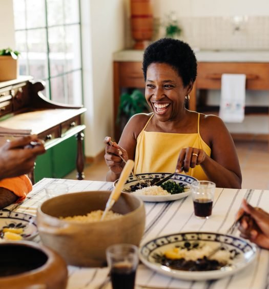 Famílias desfrutando de uma feijoada vegana em um ambiente aconchegante