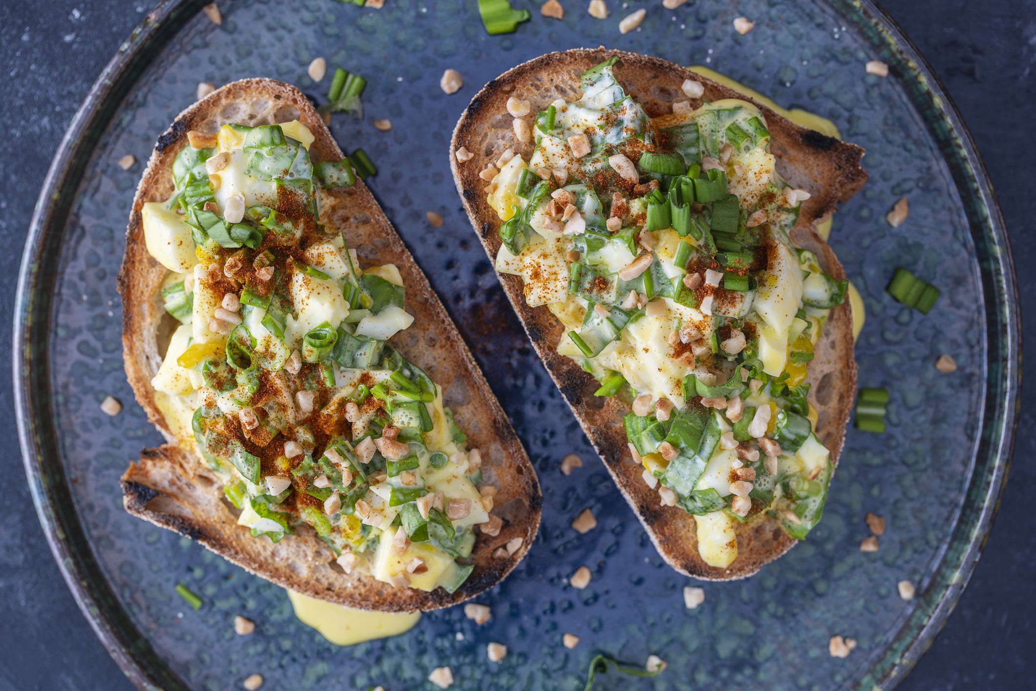 Bruschetta de alho-poró com cebola e nozes sobre um prato azul