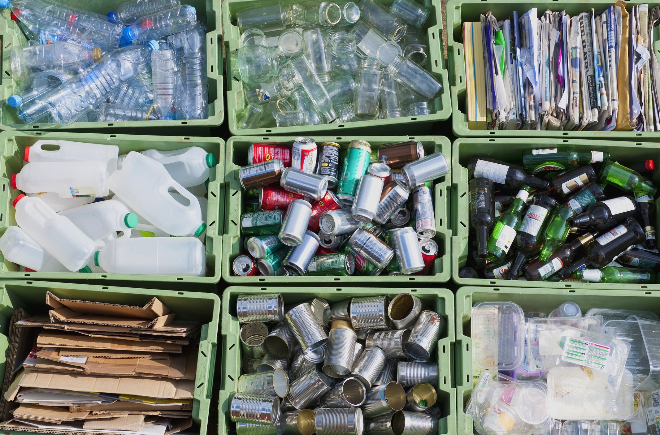 Caixas com diferentes tipos de lixo reciclável.