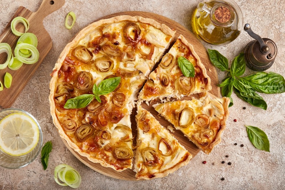 Quiche de alho-poró com fatias servidas.